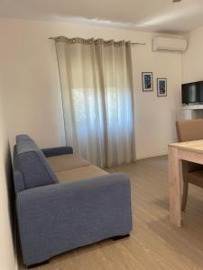 a living room with a couch and a table at Sea Rocks House in Olbia