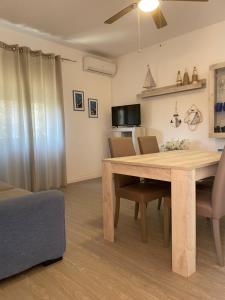 a dining room with a wooden table and chairs at Sea Rocks House in Olbia