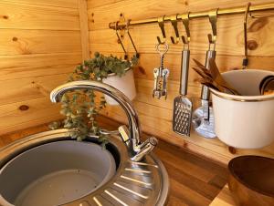 a kitchen with a sink and utensils on a wall at Avondale Lytham - Private Luxury Pod - Walk to Lytham Green in Lytham St Annes