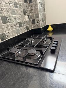 a stove top oven sitting in a kitchen at Tiwaline Tarsime App E in Sidi Ifni
