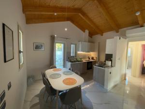 a kitchen and dining room with a table and chairs at Makis & Lena's Home in Svoronata
