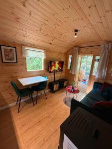 a living room with a couch and a table in a cabin at Pipowagen aan het Wandelpad in Lanaken