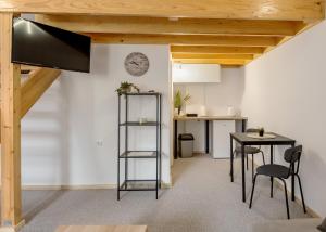a kitchen and dining room with a table and chairs at KING rooms in Bečej