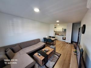 a living room with a couch and a table at Stan na dan UNO Modriča in Modriča