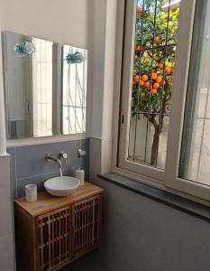 a bathroom with a sink and two windows at Chez Marie Ischia in Forio d'Ischia