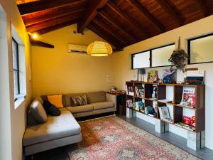 a living room with a couch and a book shelf at AGASA residence in Fujieda