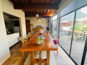 a large wooden table in a room with chairs at AGASA residence in Fujieda