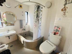 a bathroom with a toilet and a shower and a sink at AGASA residence in Fujieda +15 photos