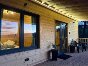 a screened in porch with a view of the mountains at The Little House in Sohodol