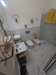 a bathroom with two toilets and a sink at B&B Kasia in Palmadula