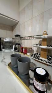 a kitchen with bowls on a stove top at Charme appartement in Mohammedia