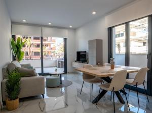 a living room with a table and a couch at Casa Lauri in Orihuela Costa