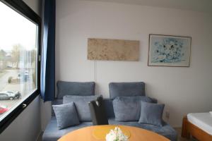 a room with two chairs and a table and a couch at FW Knütel Nr 57 in Burgtiefe auf Fehmarn 