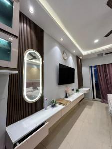 a living room with a flat screen tv on a wall at THE MOONLIGHT STUDIo in Noida