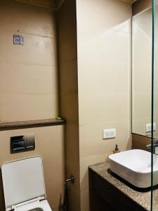 a bathroom with a toilet and a sink at THE MOONLIGHT STUDIo in Noida