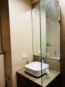 a bathroom with a sink and a mirror at THE MOONLIGHT STUDIo in Noida