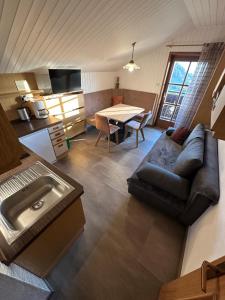 a living room with a couch and a table at Alpenrose in Meltina