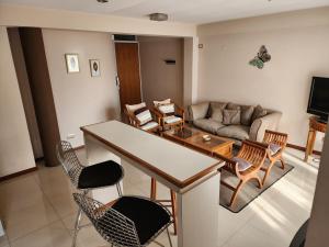a living room with a couch and a table and chairs at Piero House in Villa Mercedes