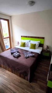a bedroom with a bed with two towels on it at Cascadas, Studio apartment with a pool view in Sunny Beach