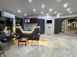 a lobby with chairs and a bar in a building at Han Dalyan Hotel in Dalyan
