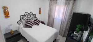a bedroom with a bed with pillows on it at Angkor Wat Village in Puerto Real