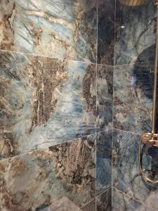 a bathroom with a marble tile floor and a shower stall at tre castelli in Monticello