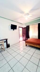 a living room with a bed and a table at Hotel Meson Mariano Matamoros in Querétaro
