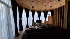 a living room with a couch and large windows at Eco Elegance in Makho