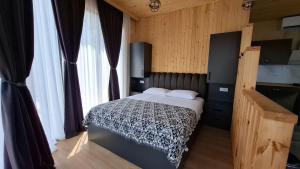 a bedroom with a bed in a room with windows at Eco Elegance in Makho