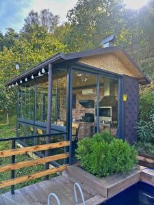 a greenhouse with a roof on a deck at Eco Elegance in Makho