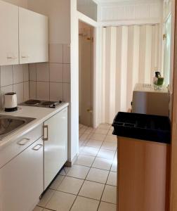 a kitchen with a sink and a counter top at Gemütliche Ferienwohnung mit Sauna & Terrasse in Monzingen