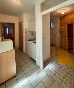 a kitchen with a sink and a counter top at Gemütliche Ferienwohnung mit Sauna & Terrasse in Monzingen +6 photos