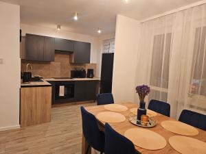 a kitchen and dining room with a table and chairs at Szybowcowa View Apartment in Jelenia Góra