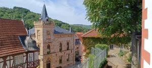 an old building with a clock tower in a town at Gemütliche Ferienwohnung mit Sauna & Terrasse in Monzingen
