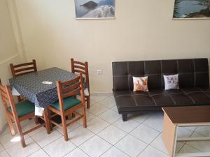 ein Wohnzimmer mit Sofa und Tisch in der Unterkunft Alkion Platana in Kími