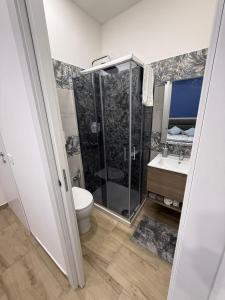 a bathroom with a shower and a toilet and a sink at Soft landing at home in CTA