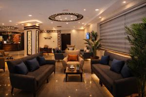 a lobby with couches and chairs and a table at Panorama Amman Hotel in Amman