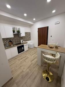 a kitchen with a counter and a stool in a room at Soft landing at home in CTA