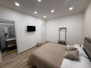a bedroom with a large bed and a bathroom at Soft landing at home in CTA