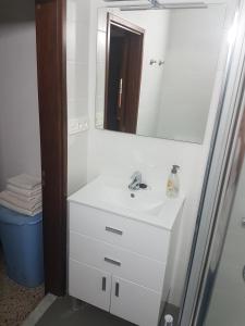 a bathroom with a white sink and a mirror at Sol y Playa in Puerto Naos +8 photos