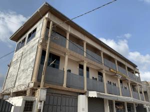 a large building with a lot of windows at Water House Lodge in Apenkwa