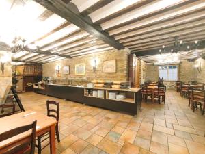 a restaurant with tables and chairs in a room at Hotel Venta de Etxalar in Etxalar