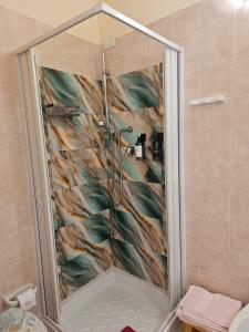 a shower in a bathroom with a fish mural at La Rosa dei Venti B&B in Chia