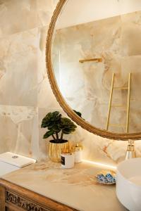 a bathroom with a mirror and a sink at Petit Palace in Lefkimmi +34 photos