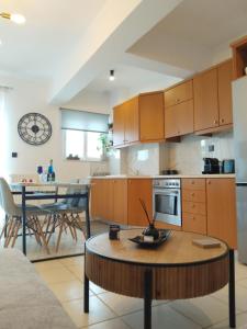 a kitchen and dining room with a table in it at Seaside Breeze Apartment in Sitia