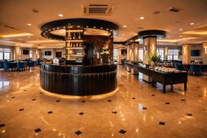 a hotel lobby with a bar and a restaurant at Panorama Amman Hotel in Amman