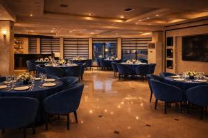 a dining room with tables and chairs in a room at Panorama Amman Hotel in Amman
