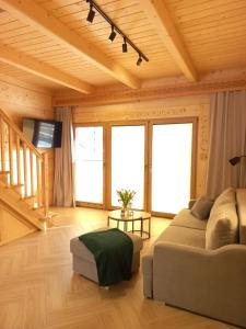 a living room with a couch and a table at Potokowe Zacisze in Zakopane