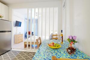 a kitchen with a table with a bowl of fruit on it at Comfort Residence in Montreal
