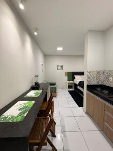 a kitchen with a table and chairs and a bed at Loft Marinês in Campina Grande +11 photos